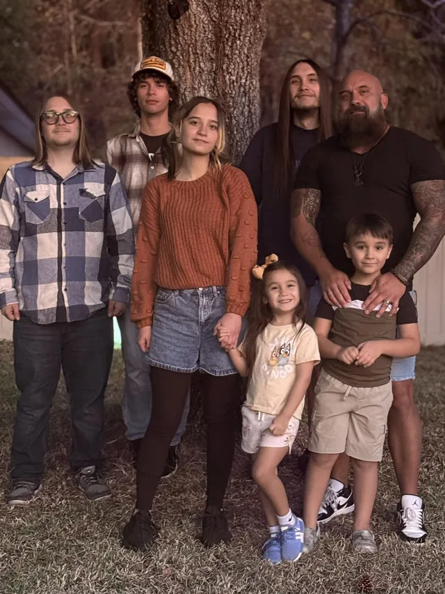 Shannon Cain outdoors with his six children